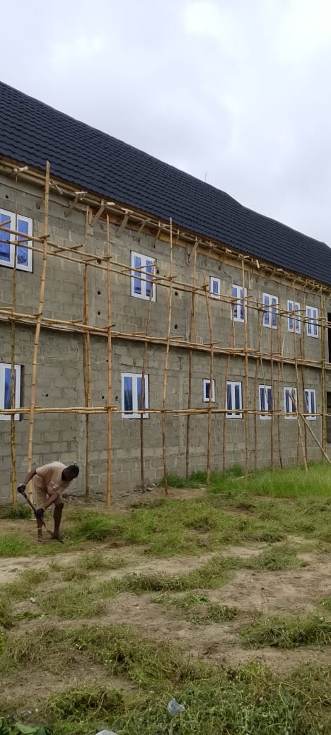 Two-storey residence with dark stone-coated roof and aluminium casement windows