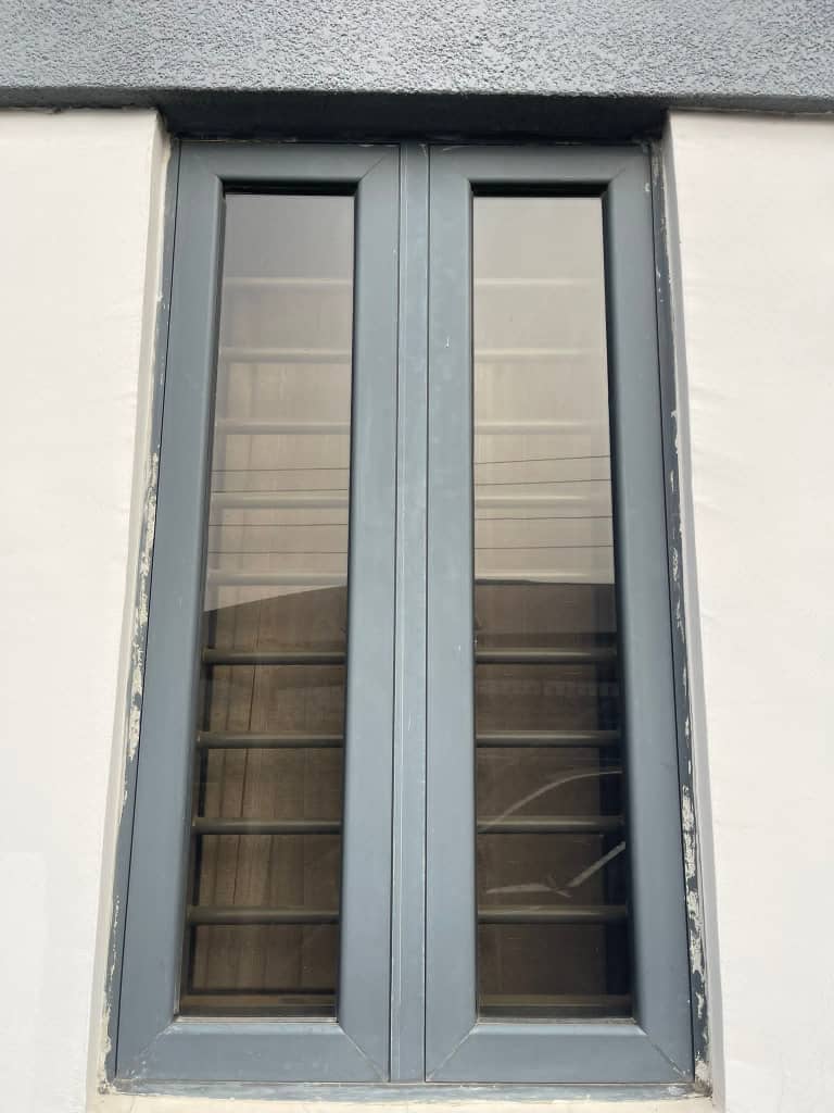 Charcoal grey aluminium window installed on modern home