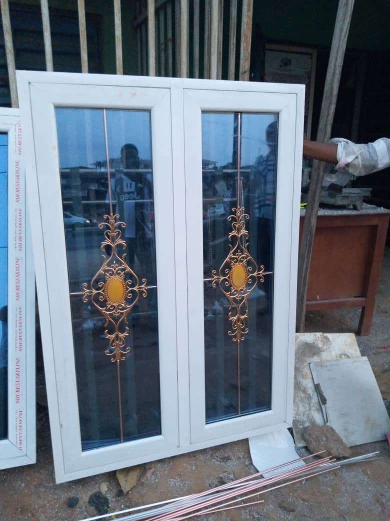 Decorative aluminium window with copper wrought-iron detail