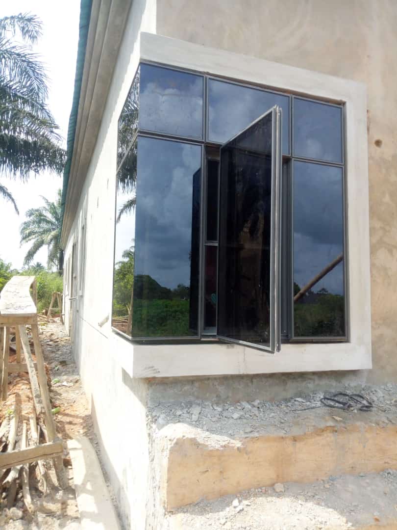 Tinted aluminium casement window with dark glazing on new build