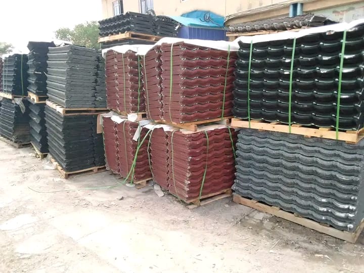 Palletised stock of black and red stone-coated roof tiles ready for delivery