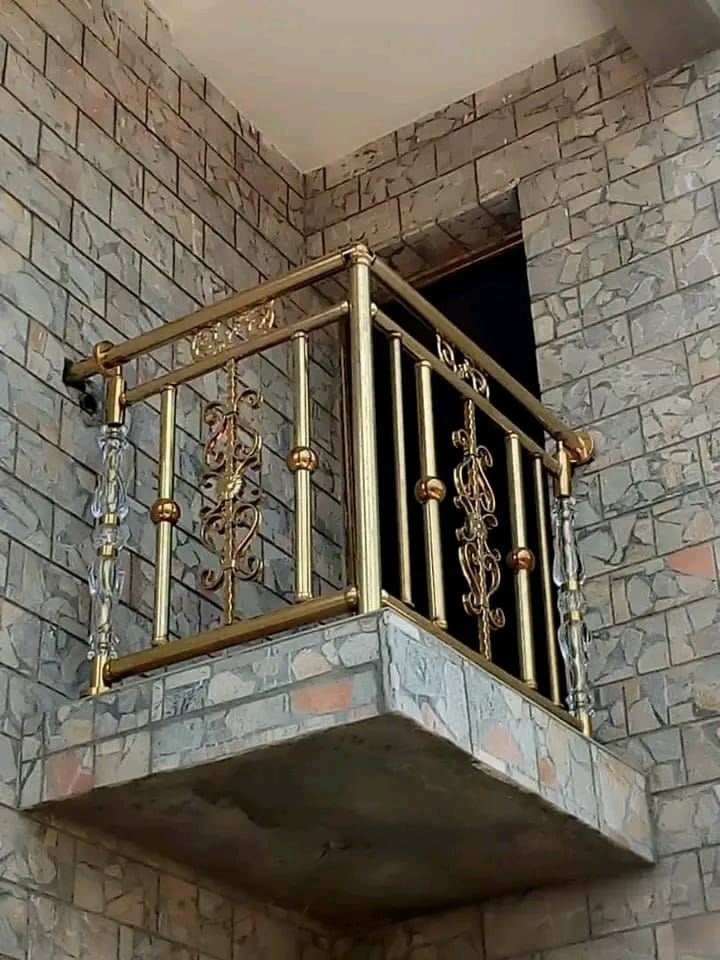 Custom brass and crystal balcony railing on stone-clad wall